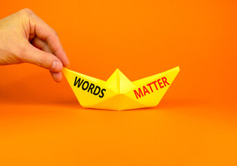 Words matter symbol. Concept word Words matter on beautiful yellow paper boat. Businessman's hand....