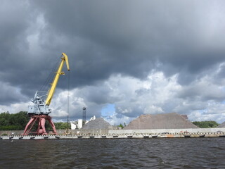 river port with crane and cloudy sky
