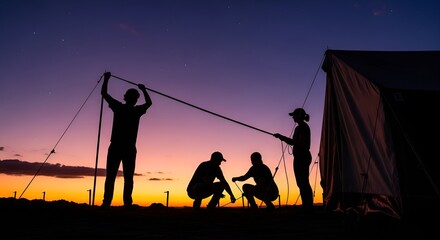 Silhouetted figures erect a tent at dusk, with one person raising a pole and others working near the tent's base against a colorful sunset sky.