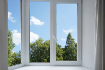 Fototapeta premium View from the window on the garden green trees. 