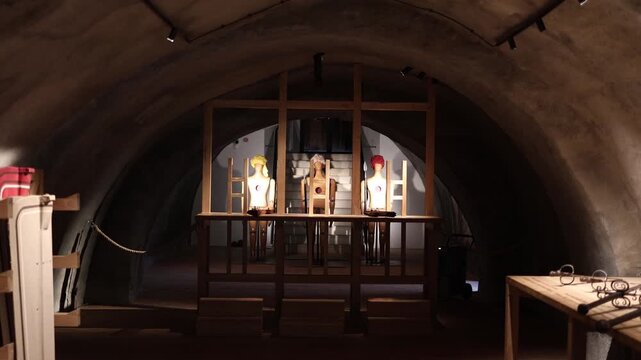 Three wooden training mannequins with target marks stand under spotlights in an arched shooting range room creating an atmosphere of historical weapon practice and marksmanship