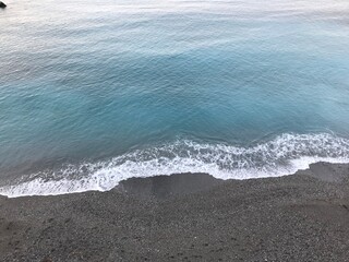Gentle ripples moving across the clear Mediterranean sea.
