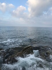 Soft morning glow over a coastal town and cliffs.
