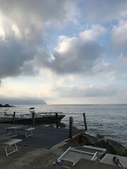 Waves rolling onto a stony beach in summer.
