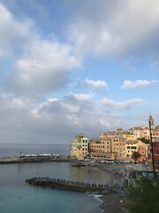 Crystal-clear blue sea beside rugged Mediterranean cliffs.
