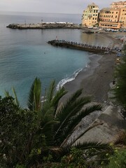 Golden sunlight touching the rocky shore of an Italian coastal town.
