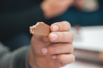 man eating chocolate with a knife in a cafe