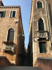 Sunset view over canals and historic houses in Venice.

