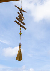 Obraz premium Driftwood wind chime with beads and a tassel.