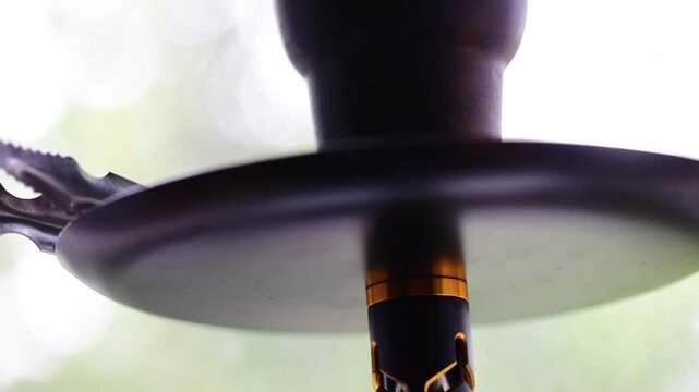 Hoad hook is close -up against the background of nature. Tobacco smoking device
