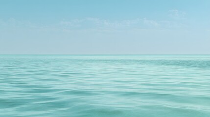 Fototapeta premium Tranquil expanse of pale turquoise water and sky.