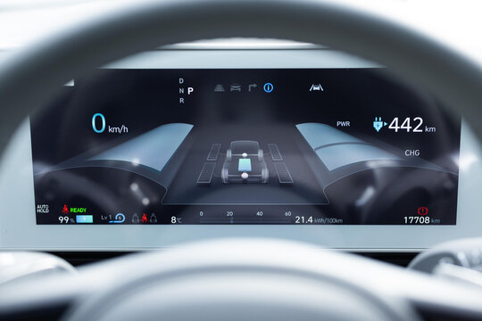 Dashboard in the electric car. Many different electric car dashboard lights with warning lamps illuminated. Starting electric car engine. Tachometer Gauge of Starting and Stopping Car - Powered by Adobe