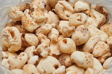  Close up of puffed corn snack inside an open bag isolated on white background highlighting crunchy texture sweetness and handcrafted simplicity.
