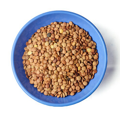 A blue bowl filled with brown lentils captured from above, isolated on white background.