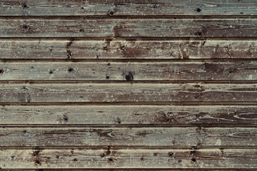 Fototapeta premium background of old weathered and cracked boards with peeling paint of brown color