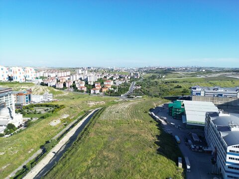 Aerial view of the urban landscape meets the natural world, where buildings contrast with green fields, Arnavutk&Atilde;&para;y, &Auml;&deg;stanbul, T&Atilde;&frac14;rkiye.