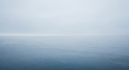 Fototapeta premium Fog over the sea creates a serene and tranquil seascape scene