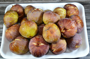 Pile of figs parchment fruit, fig is the edible fruit of Ficus carica, a species of small tree in the flowering plant family Moraceae, native to the Mediterranean region, western and southern Asia