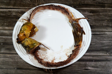 remnants of Smoked salty Herring forage fish, salt-cured and smoked, also known as silver darlings, harvested for their flesh and eggs, and they are often used as baitfish
