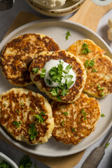 Vegetarian cauliflower pancakes, fritters served with sour cream 