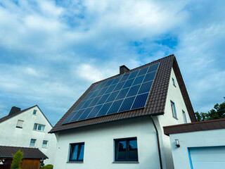 This modern home is equipped with solar panels that efficiently harness renewable energy, all set on an ecofriendly roof, showcasing a commitment to sustainability and innovative design