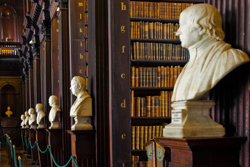 Naklejka premium Historic Library Interior with Marble Busts and Bookshelves in Dublin