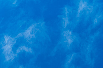 Background blurry photo of blue sky with blurry translucent cloud remnants. Natural Surroundings as a Blank in Design Artworks