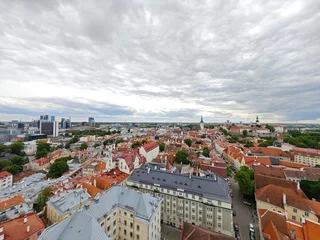 Fotobehang Smalle Straten Aerial view of Tallinn Old Town, Estonia, showcasing historic medieval architecture, red rooftops, narrow cobblestone streets, and city walls. The image captures the charming and well-preserved herita  © Fotoleaf