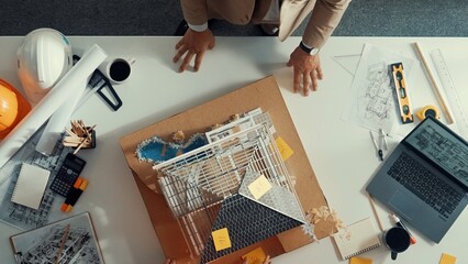 Close up of civil engineer hand holding blueprint while working together to plan building...