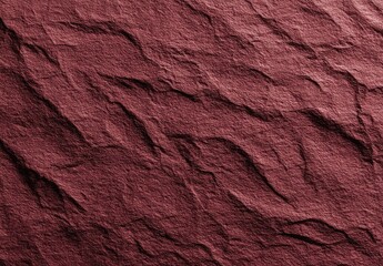 Close-up view of a deep maroon stone surface with textured ridges and valleys