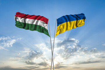 Waving National flag of Ukraine and flag of Hungary for international unity