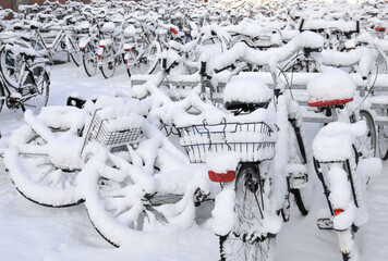Snow-covered bicycles at a winter bike parking area in the city of Münster, Germany near main railway station © Moritz