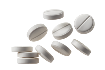 Stacked and scattered white oval pills with score line isolated on a transparent background white pills