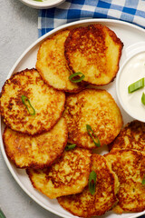Potato pancakes with  sour cream .top veiw
