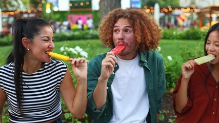 Happy multi ethnic couple enjoying ice cream in park - Powered by Adobe