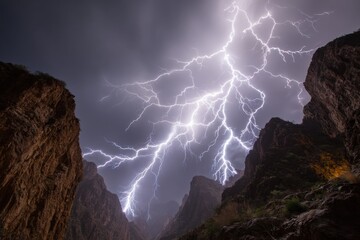 Intense lightning storm over canyon with jagged cliffs and dark sky.