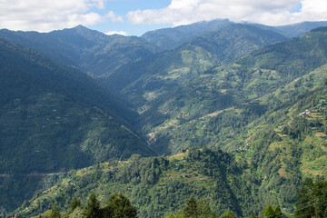 Naklejka premium Sun rays falling on Himalayan mountain range, scenic beauty of layers of mountains, Okhrey, sikkim, India. Okhrey village a remote place in Sikkim where mountain range view is enjoyed by tourists.