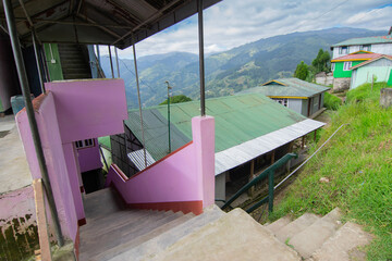 Stair cases leading to homestay at Okhrey village, Himalayan mountain range in the background . Okhrey is a remote village with scenic natural vista in Sikkim, India.