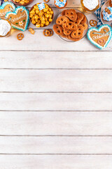 Oktoberfest festive food, with various snacks, sweets, desserts, pretzels, beer jelly, gingerbread cookies hearts, salted crackers, popcorn, jam donuts, cupcakes. Oktoberfest brunch menu background