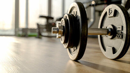 Gym with a barbell or dumbbells in the sun