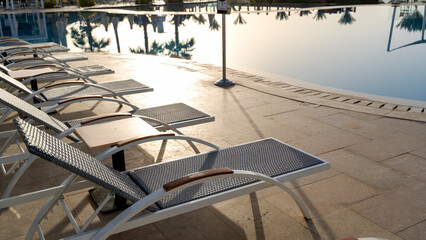 Sun loungers on the beach by the pool on the sea