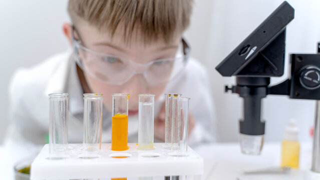 The boy conducts chemical experiments in the laboratory