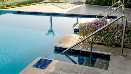 Entrance to the pool near a beautiful hotel by the sea