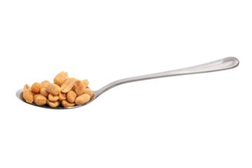 Roasted and salted peanuts on stainless steel spoon isolated