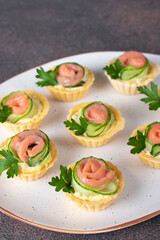 Tartlets in shape of roses with salted salmon and cucumber, festive snack for Mother's Day, Valentine's Day or birthday