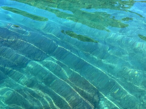 Sea calm rippled clear water surface.