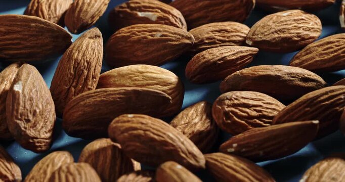 Almonds Moving and Shifting in Slow Motion &ndash; Close-Up of Raw Nuts in Natural Light, Emphasizing Texture, Shape, and Organic Quality of This Healthy Ingredient for Cooking and Snacking Use