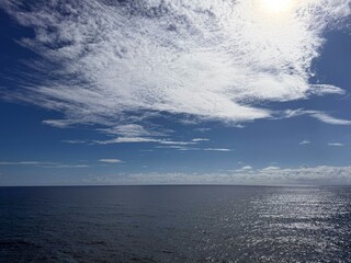 Beautiful sky clouds over glittering ocean.