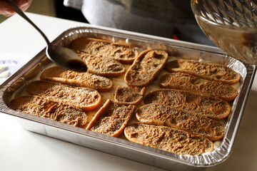 Woman making Tiramisu dessert in the kitchen