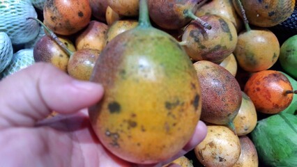 Fresh of Markisa konyal or passion fruits for sale at supermarket in Indonesia